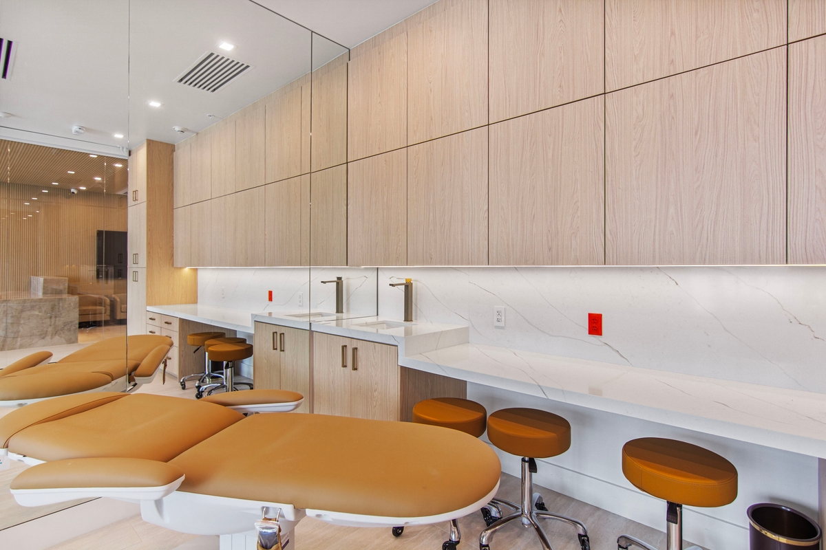 Treatment chairs positioned beside built-in oak cabinetry and a nursing station counter