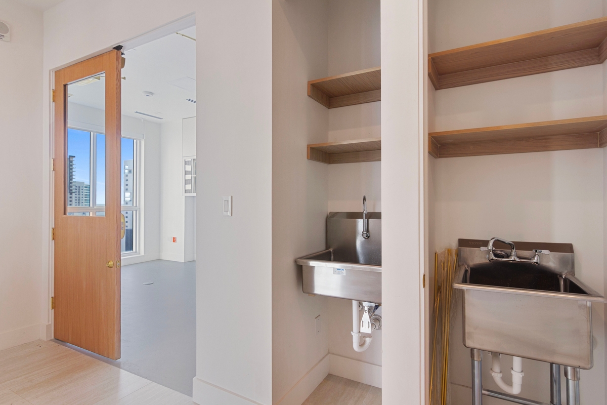 Scrub sink with foot pedal control and adjacent cabinetry