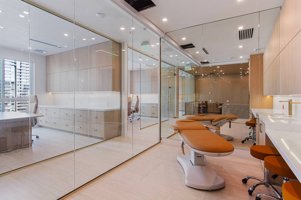 Glass-enclosed aesthetic and Med Spa treatment area with treatment chairs
