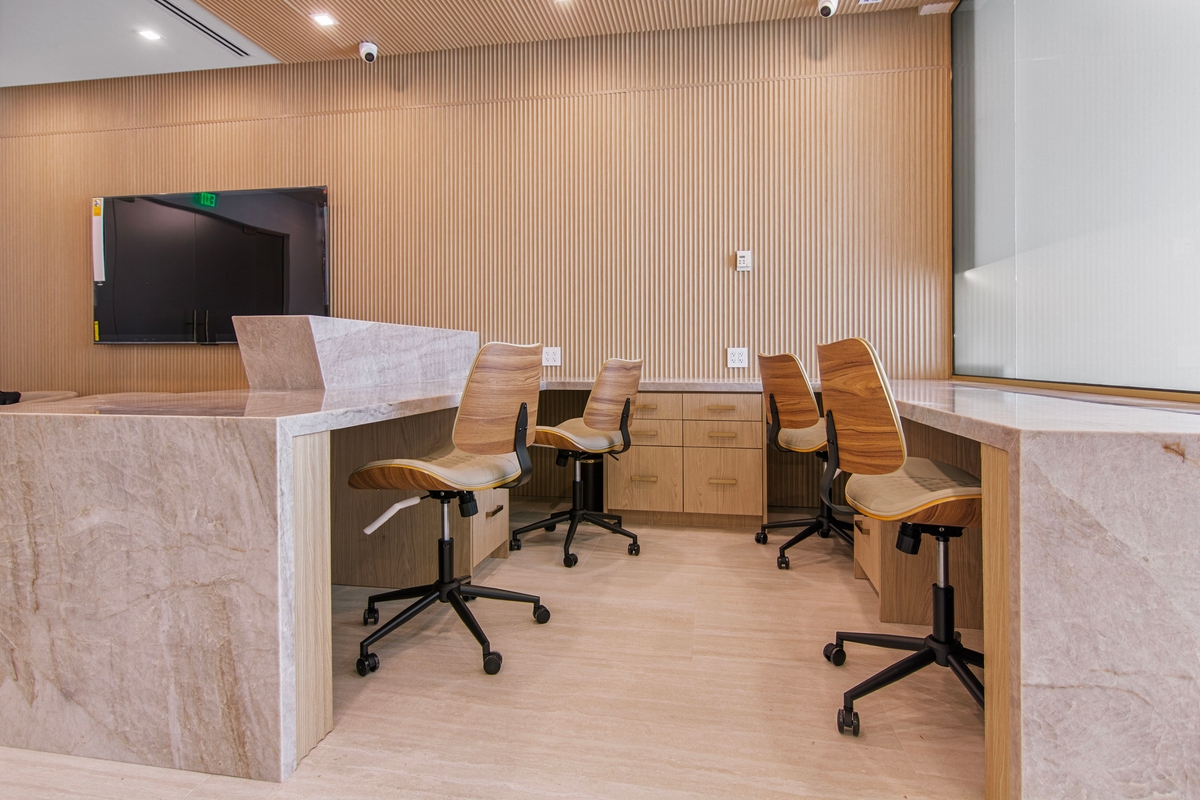 Four-station reception workstation area with custom stone counter