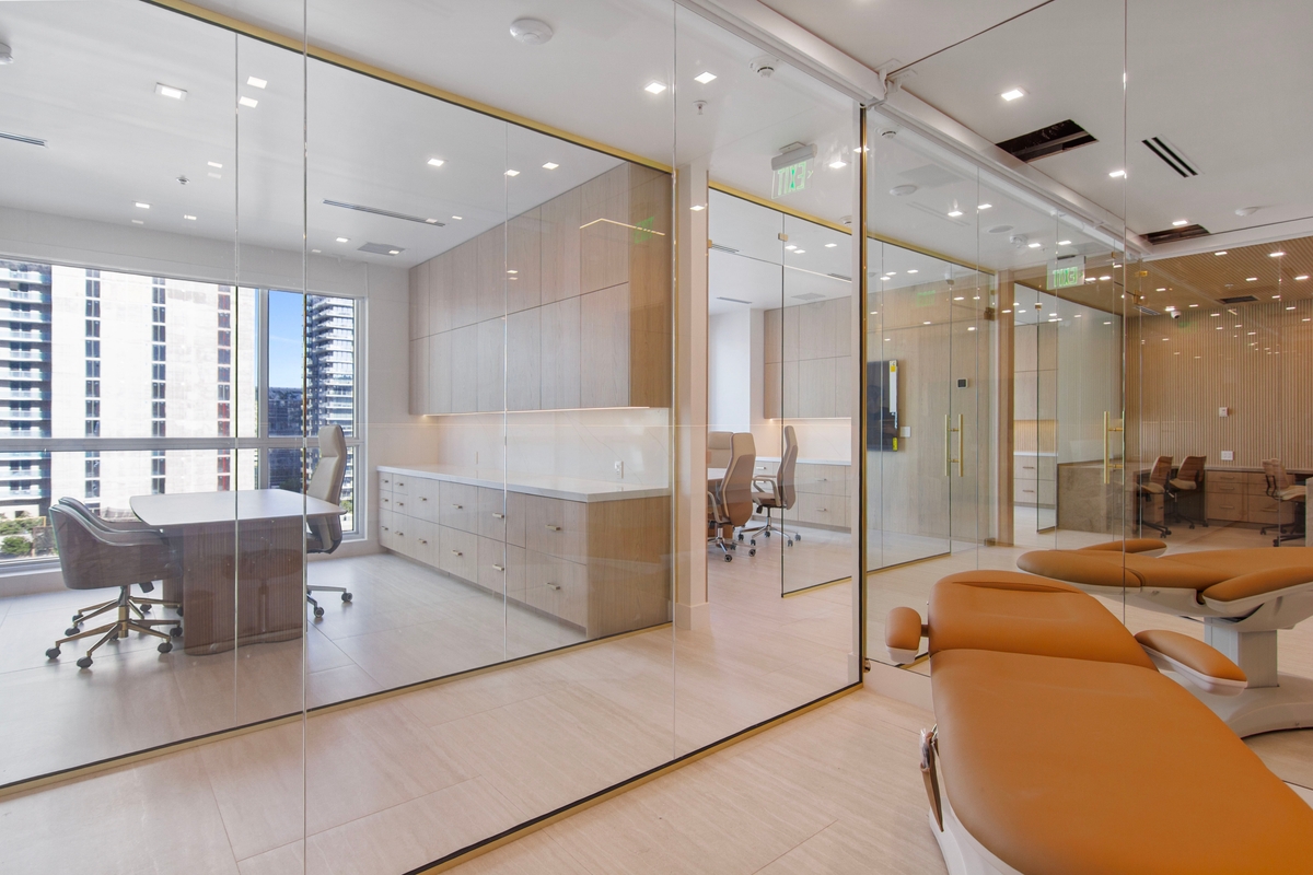 Glass-partitioned office suite showing the interior transparency of the buildout