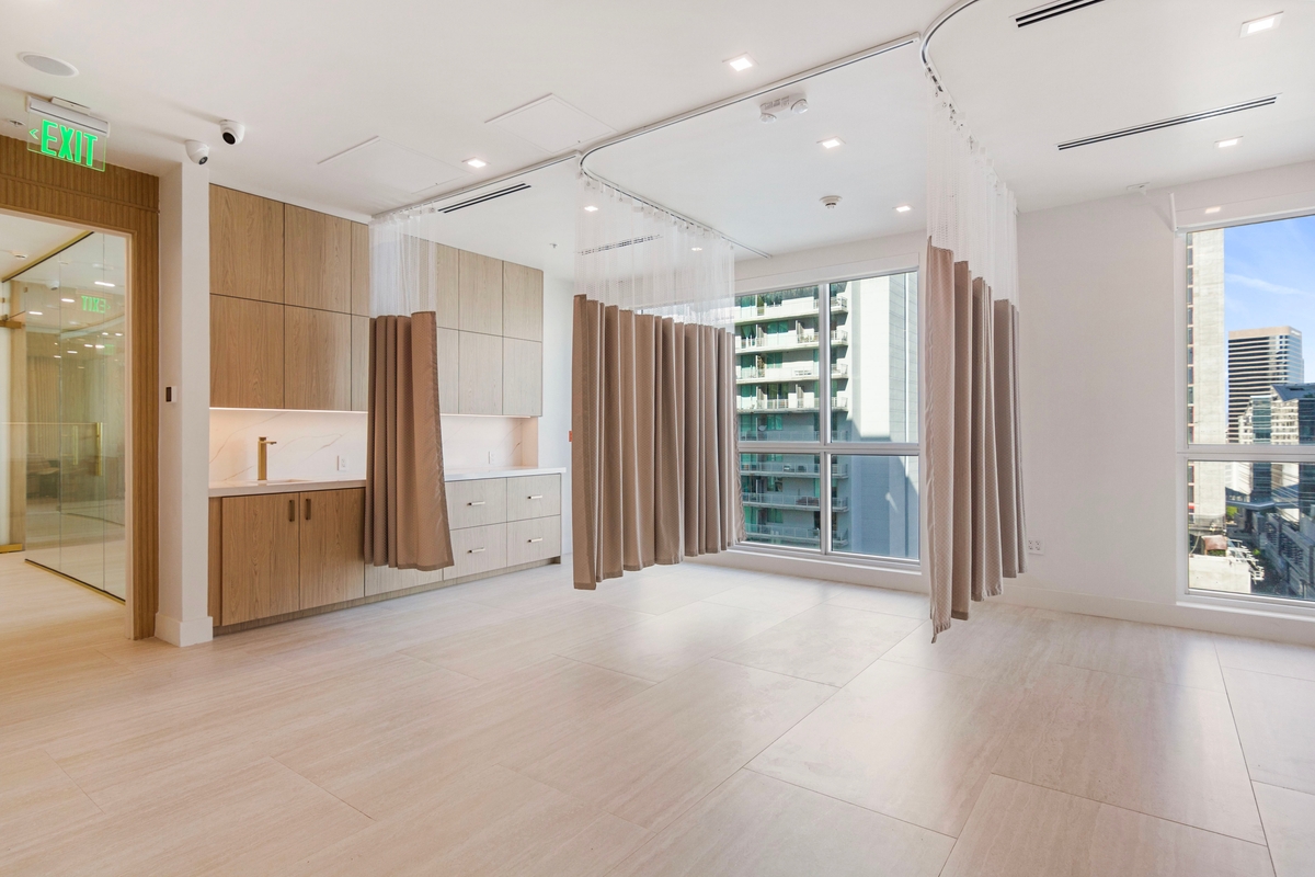 Recovery zone circulation with cabinetry, curtain tracks and access to adjoining clinical rooms