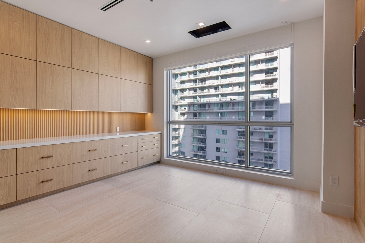 Nursing station with custom cabinetry, work counter and natural light from the window wall