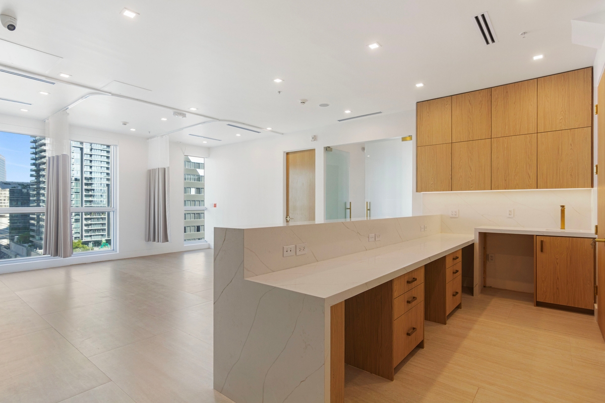 Custom oak workstation island with storage beneath and clinical circulation on both sides